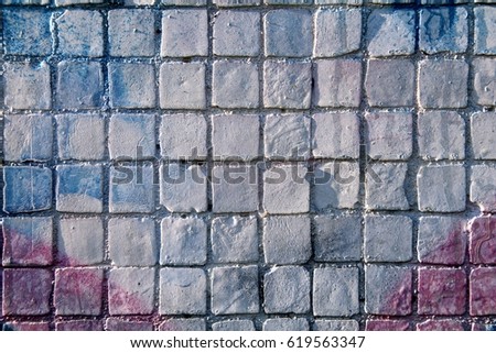 Painted blue and gray mosaic brick tile wall, close up of graffiti texture, with vibrant colors for creativity, imaginative backgrounds and ideas.
