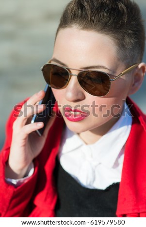 Model with phone on blurred background during the day