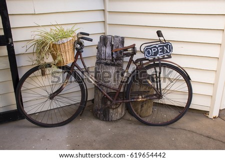 Old Rustic Bike with open sign on the rear.