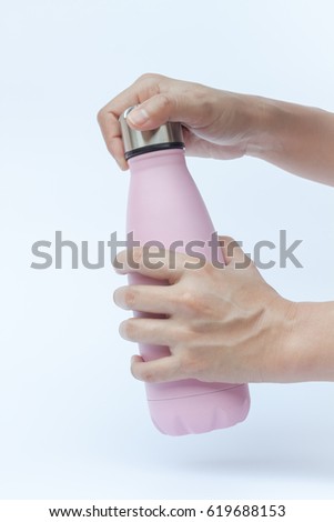 Woman hand holding warm bottle isolated on white background, stock photo