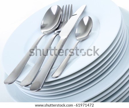 plate and cutlery on white