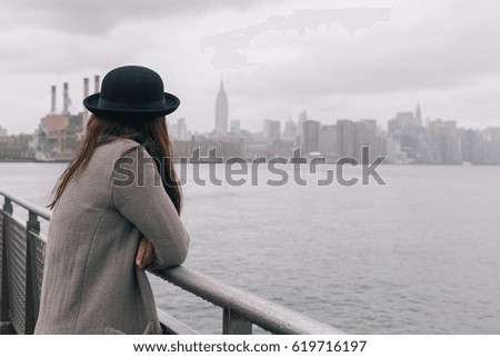 Asian Woman Standing in Brooklyn Looking at Manhattan on Rainy Day