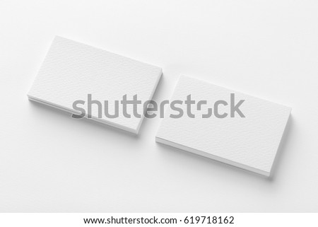 Mockup of two blank horizontal business cards stacks at white textured background. 