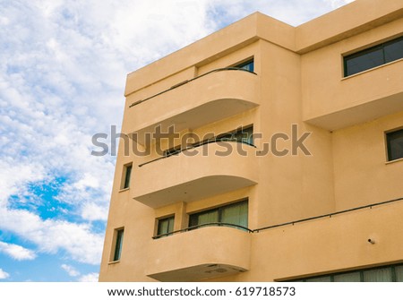 Tall apartment building. New modern block of flats with blue sky