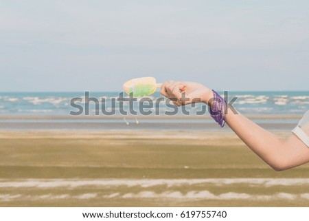 Woman holding ice cream on the beach