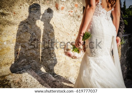 Shadow of a kissing newly-married couple