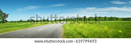 asphalt road panorama in countryside on sunny summer day Royalty-Free Stock Photo #619799693