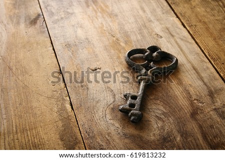 Image of antique key on old wooden table. Royalty-Free Stock Photo #619813232
