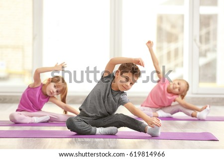 Group of children doing gymnastic exercises Royalty-Free Stock Photo #619814966