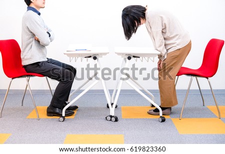 Woman apologizing to interviewer Royalty-Free Stock Photo #619823360