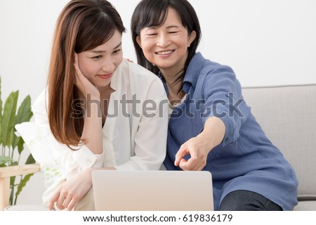 Parents and children using a laptop computer, mother, daughter, smile