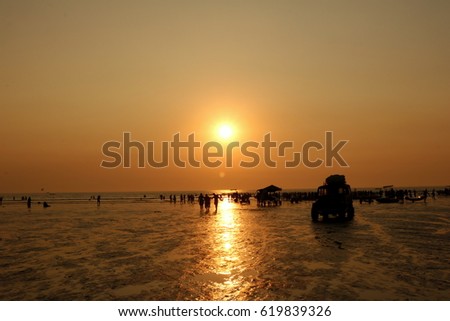 People enjoying on beach, silhouettes during sunset