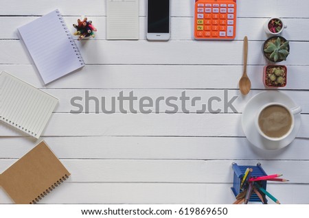 Office stuff and it gadgets display on top view business desk with copy space at text of picture. Creative table, modern project. Business mockup at empty smartphone finance device on wood background.