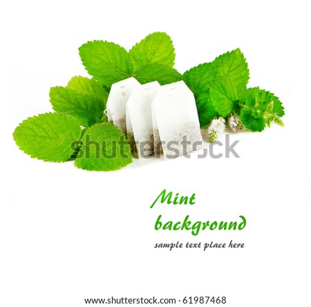 Teabags and fresh mint leaves in white. Shallow DOF