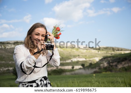 A young woman with camera in a good mood