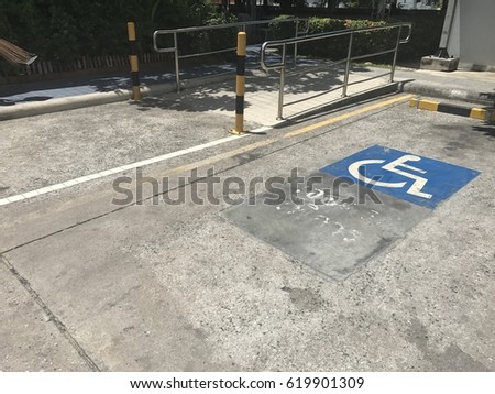 Parking for people with disabilities space outdoor. Ramp for people with disabilities. Slot empty space parking with sign for people with disabilities for