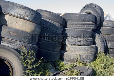 Black tyres abandoned on the ground, a sign of pollution


