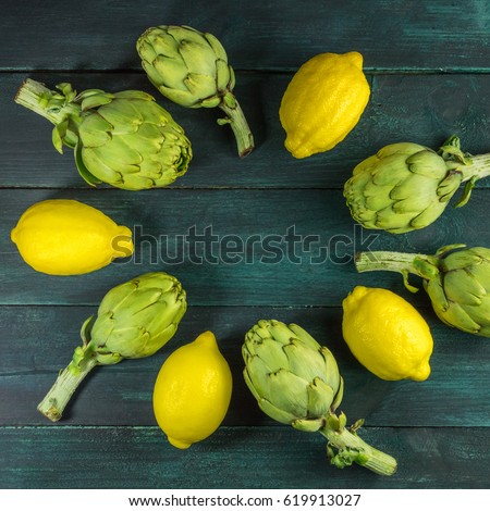 A square photo of artichokes and lemons, forming a frame for text on a dark rustic texture