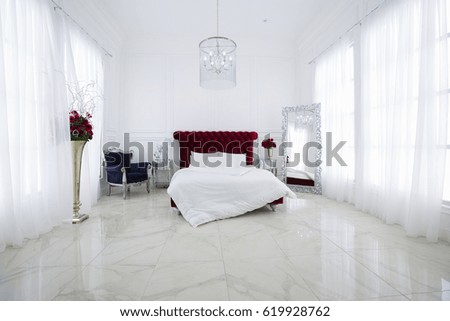 Luxury white light bedroom interior design. Dark red large bed