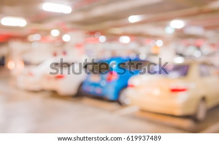 abstract blur image of indoor car park with bokeh for background usage . (vintage tone)
