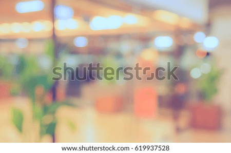 Abstract blur image of modern office with bokeh for background usage . (vintage tone)