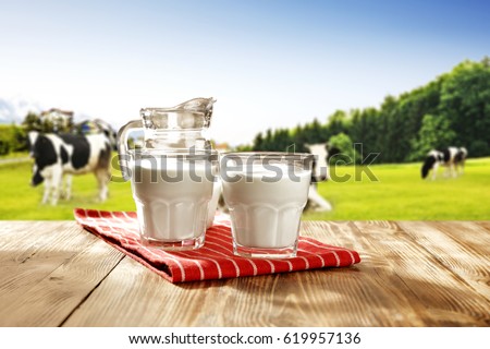 milk and landscape with green grass  Royalty-Free Stock Photo #619957136