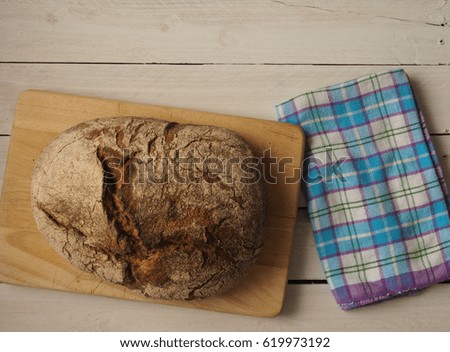 Tasty bread on a rustic wooden background with space for text, view from above