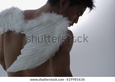 Man wearing angel wings