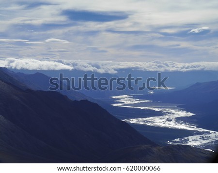High mountains in alaska with a meander river