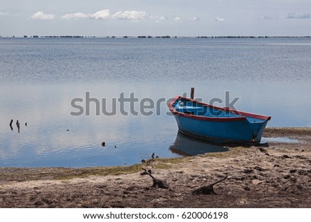A singe boat on the coast Rhone river delta at sunny day, Camargue, Provence, France