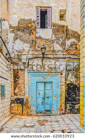 Traditional old painted door in a historical district or medina, Tunisia. Colorful textured image of muslim architecture.