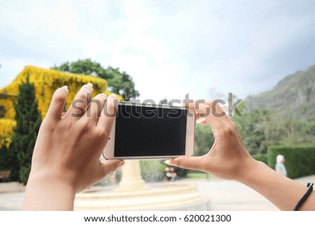 Woman using a smart phone to take photo