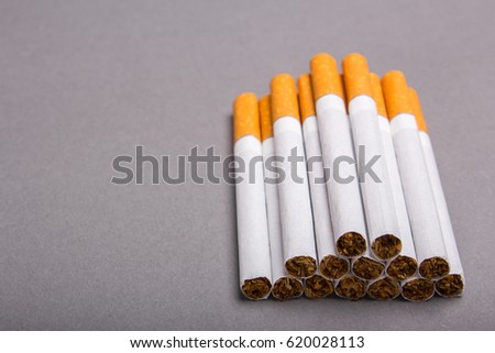 Cigarettes cause cancer and kill. Empty place for text. Gray background
