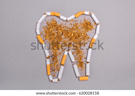 Cigarettes cause cancer and kill. Gray background
