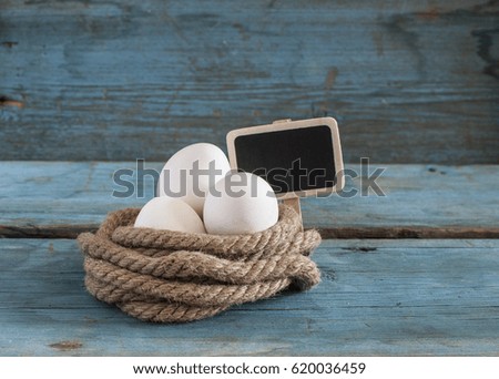 fresh egg with pile rope on wood table background