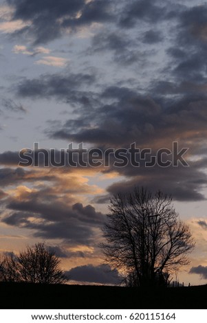 A sunset with bright and dark clouds