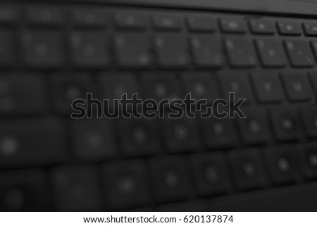 laptop keyboard blurred background or texture image with side perspective