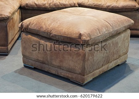 Big leather footstool in living room Royalty-Free Stock Photo #620179622