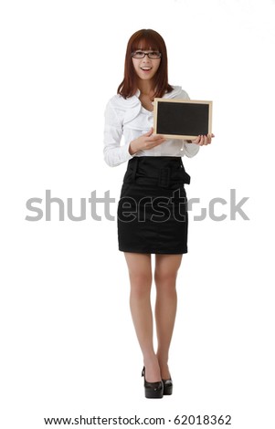Smiling business woman holding blank blackboard, full length portrait isolated on white.
