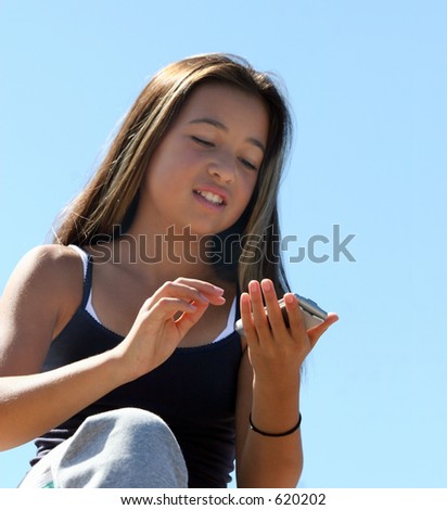 Teenage girl dialing a number. Focus on hands