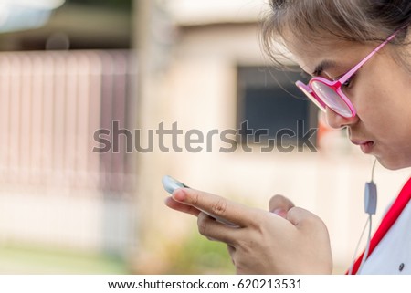 The girl glasses play a phone call.