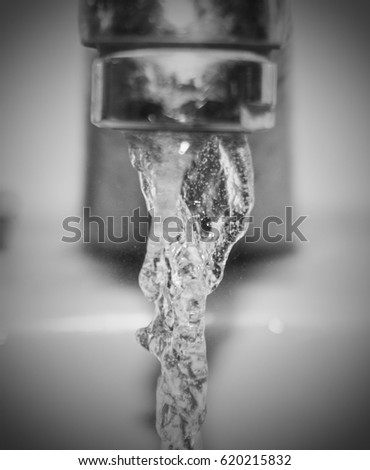 A close-up photograph of water running from a bathroom tap. This photo was taken in Brisbane, Australia. 