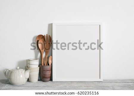 kitchenware with frame photo on wooden shelf.
