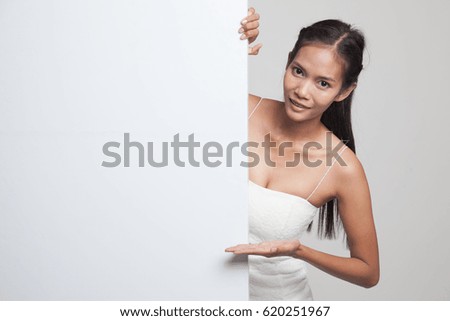 Young Asian woman present blank sign with palm hand  on gray background