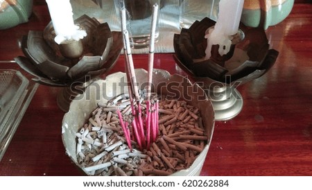 Incense sticks in vases to pay homage to the New Year.