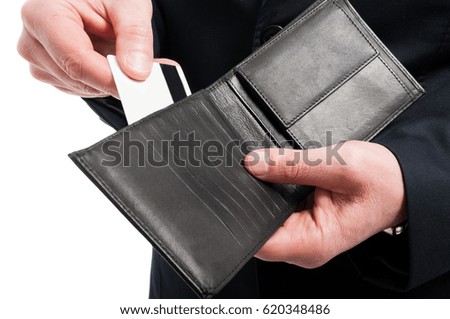 Close-up of man showing his credit card in wallet wearing suit isolated on white background