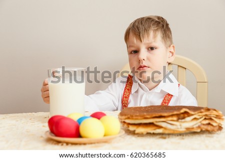 boy in the shirt at the table with the milk, healthy diet, Easter eggs, Easter
