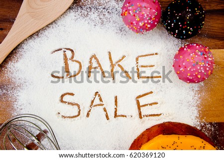 Bake Sale with cake written in flour
