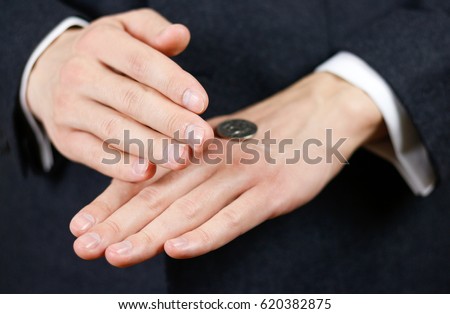 Businessman tossing a coin. Heads or tails. Close up.