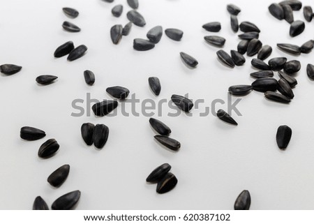 Black seeds lie on a white background